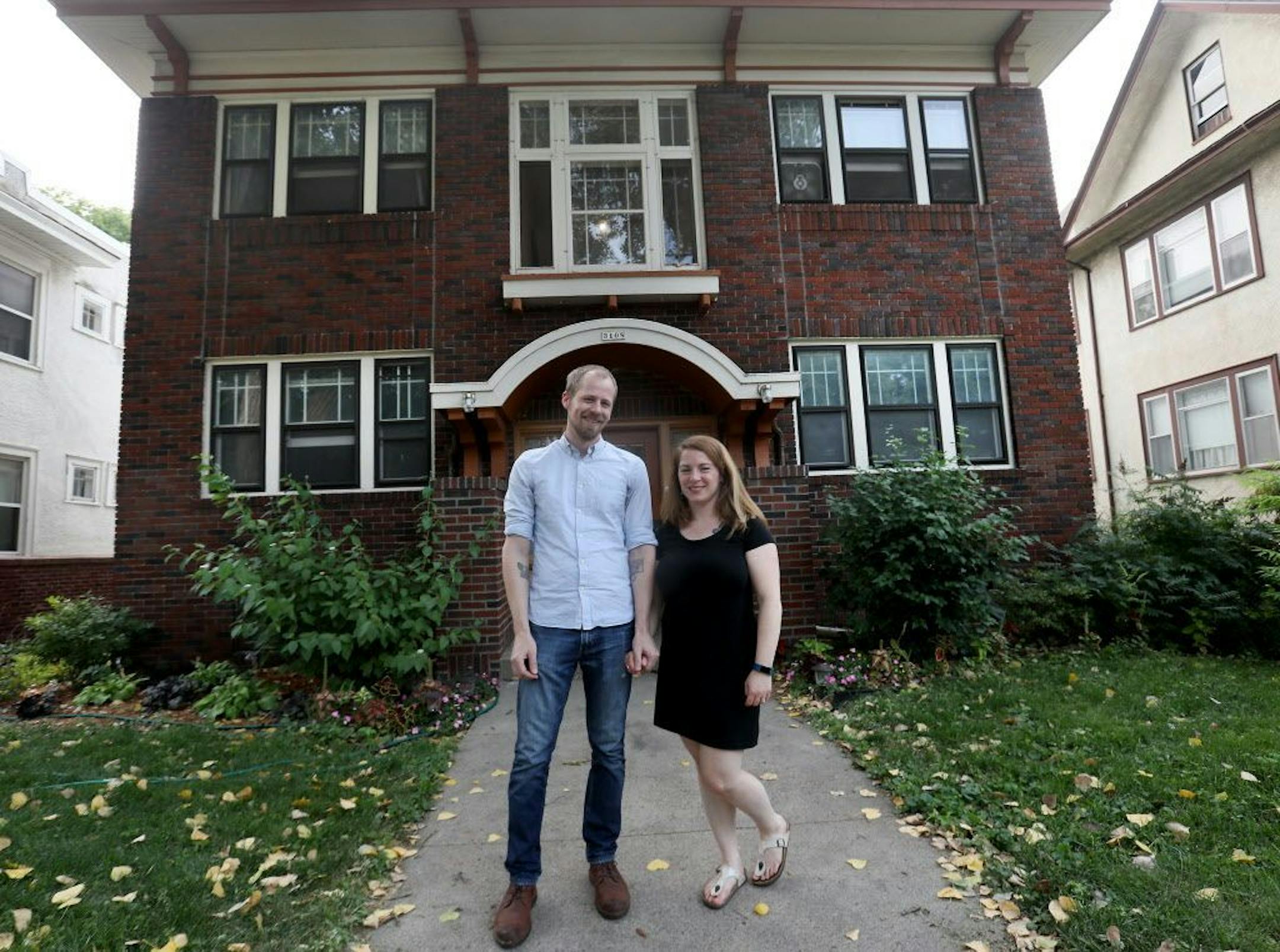 Matt Lewis and Natalie Wagner outside their condo in a fourplex, built in the 1920s near LynLake.