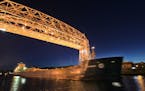 A freighter sailed under the Lift Bridge in Duluth in this file photo. Business at the port is up, the Marine Chamber of Commerce said.
