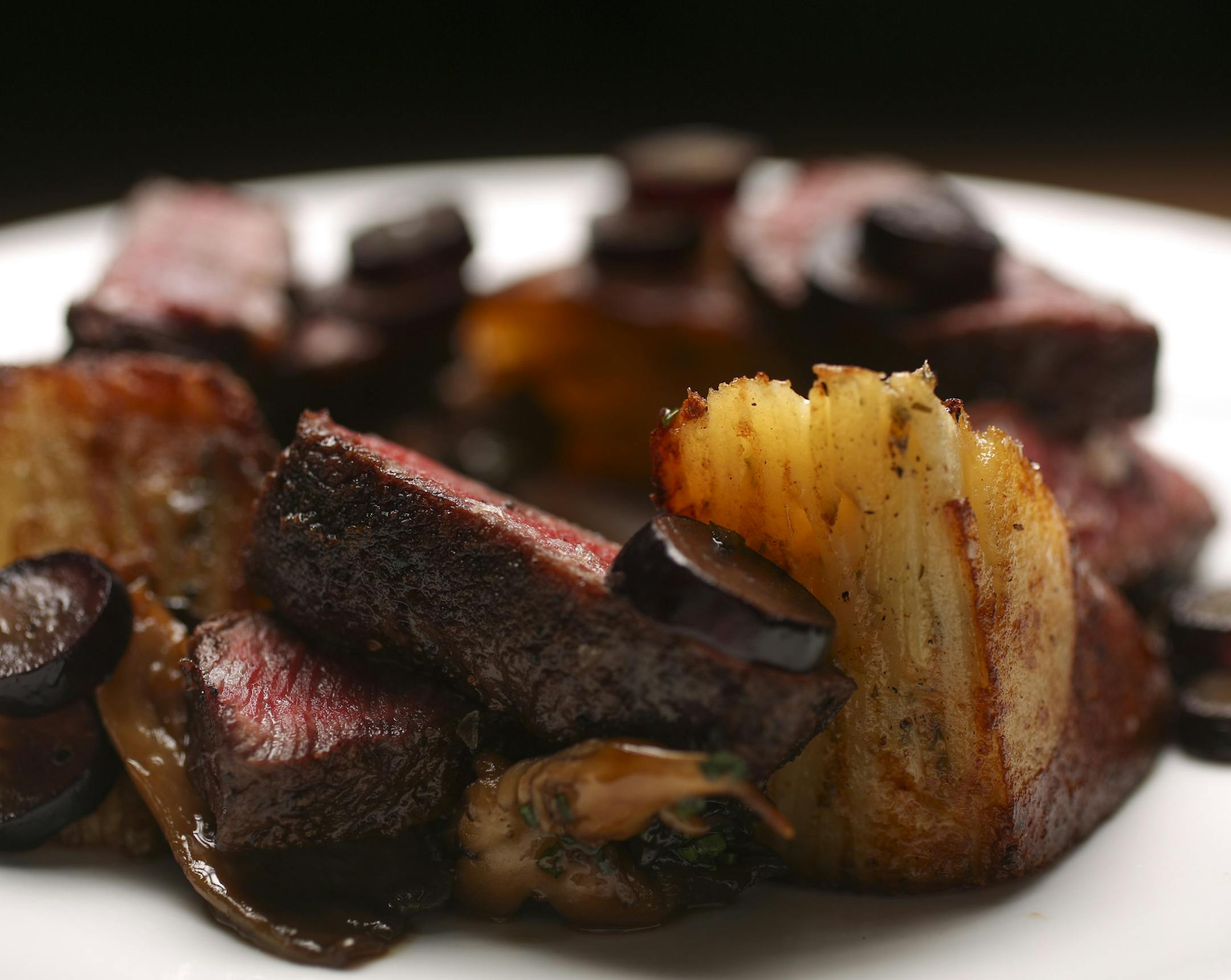 The Snake River Wagyu flatiron steak, with glazed mushrooms, scalloped potato and grapes at Eastside.