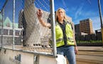 Debra Hilmerson, a veteran construction-site safety consultant, with her Hilmerson Barrier Fence System, outside a construction site in Downtown Minne