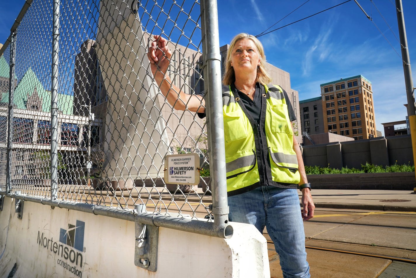 Debra Hilmerson, a veteran construction-site safety consultant, with her Hilmerson Barrier Fence System, outside a construction site in Downtown Minneapolis. ] GLEN STUBBE • glen.stubbe@startribune.com Monday, July 13, 2020