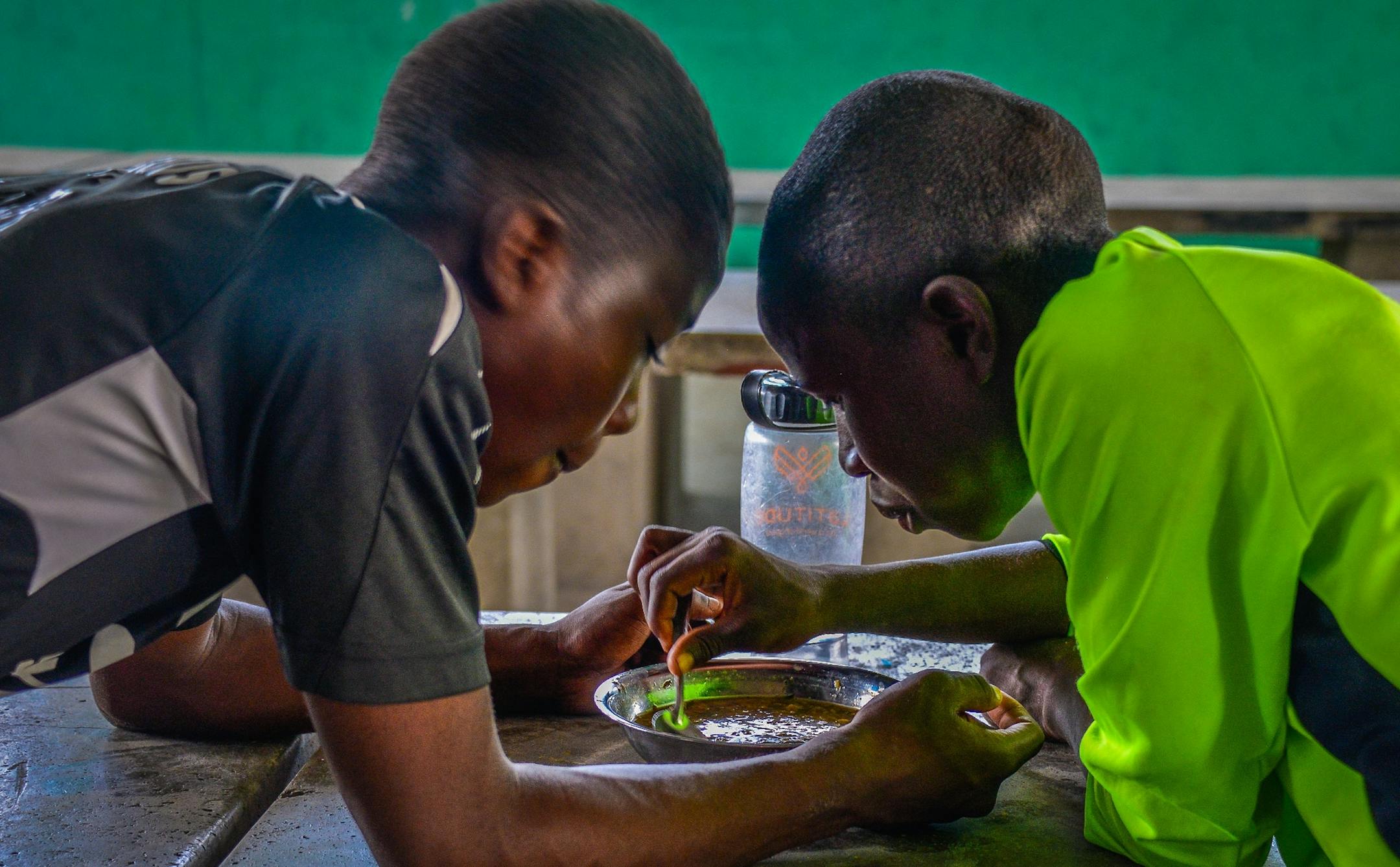 Sharing a meal. The boys get a hot, vitamin fortified meal from Feed My Starving Children after each practice or game (don't have IDs on the kids)