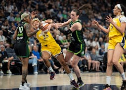 Lynx guard Courtney Williams (10) and forward Bridget Carleton (6) collide with Sparks guard Layshia Clarendon (25) as she races toward the basket in 