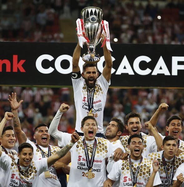 Chivas players hold the trophy aloft as they celebrate winning the CONCACAF Champions League final soccer match in Guadalajara, Mexico, Wednesday, Apr