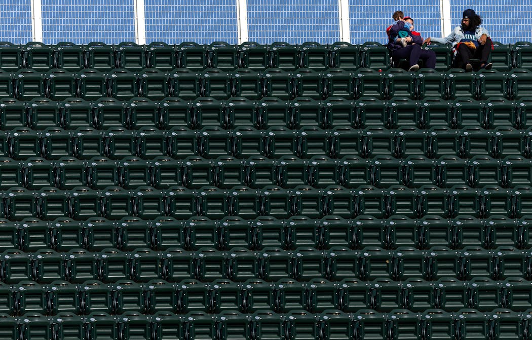 Two fans watched the final home game from the top row of the third deck in the outfield.