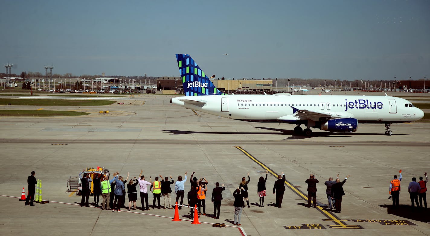 JetBlue's head of air service, and ground crew members waved goodbye as JetBlue flight 836 begins service at MSP to Boston Thursday.