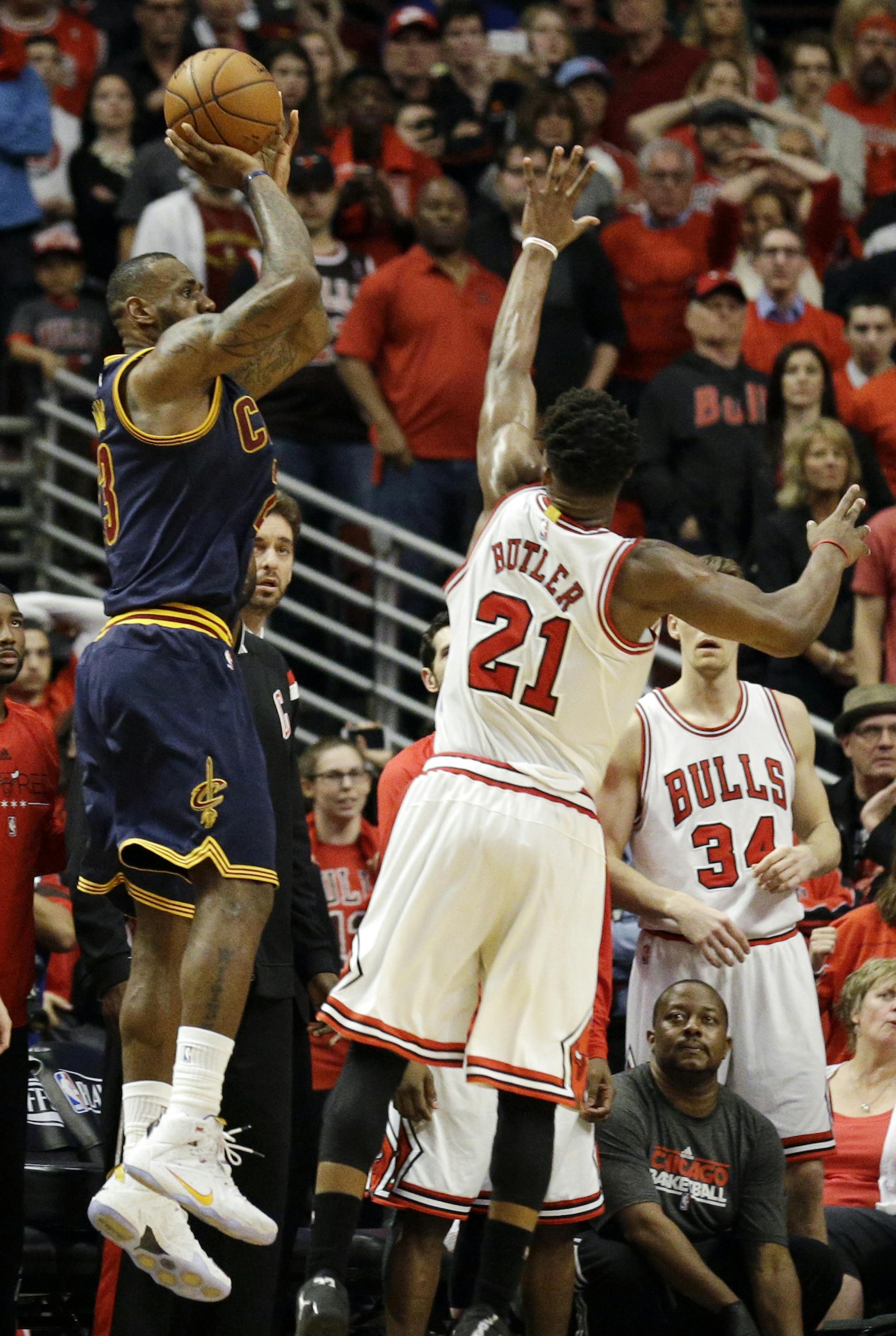 Cleveland Cavaliers' LeBron James, left, shoots the game-winning shot against Chicago Bulls guard Jimmy Butler during the second half of Game 4 in a second-round NBA basketball playoff series in Chicago on Sunday, May 10, 2015. The Cavaliers won 86-84. (AP Photo/Nam Y. Huh)