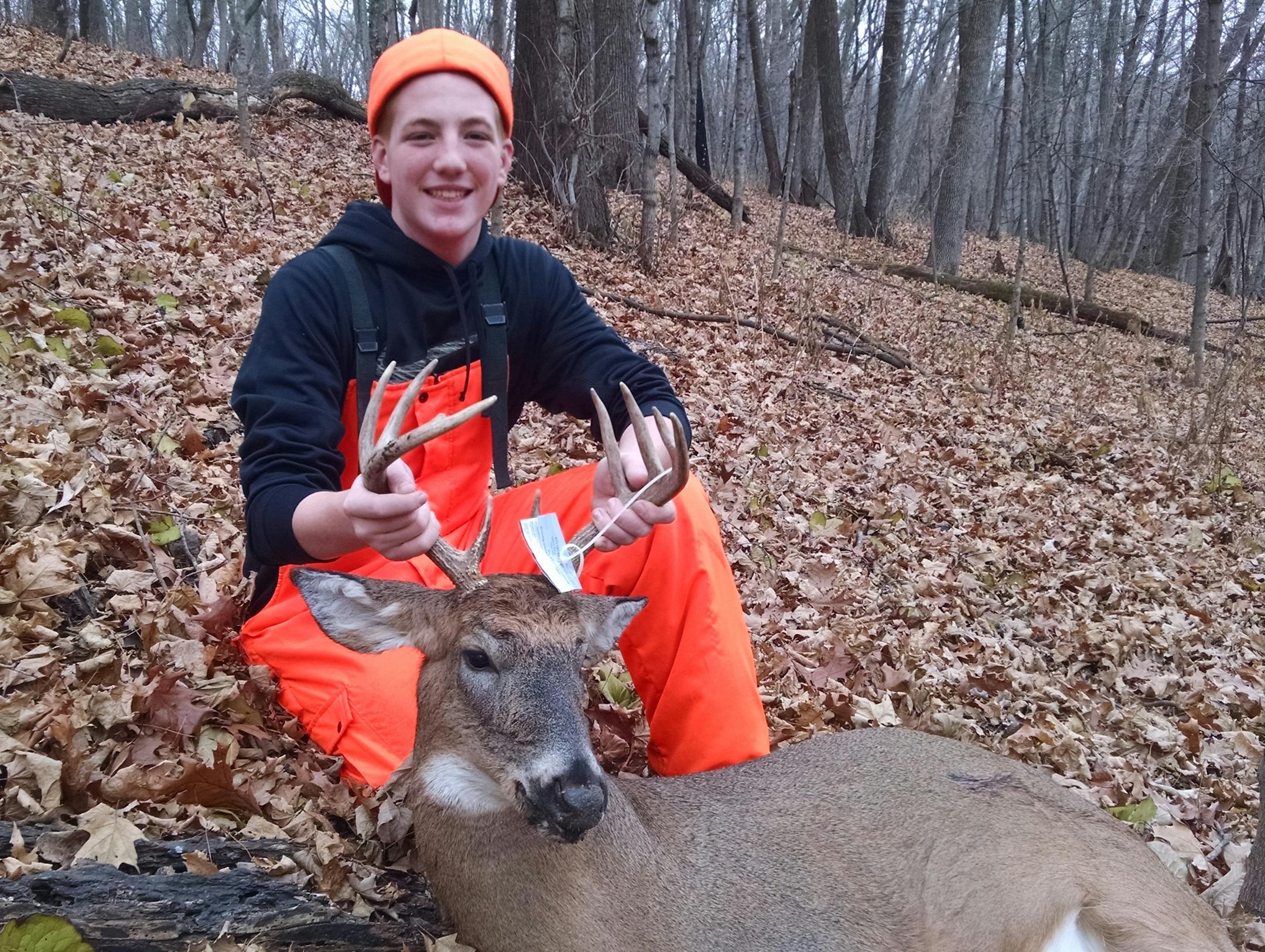 Evan Halet, 14, of Minneapolis, with a buck he bagged Sunday -- and found after some searching.