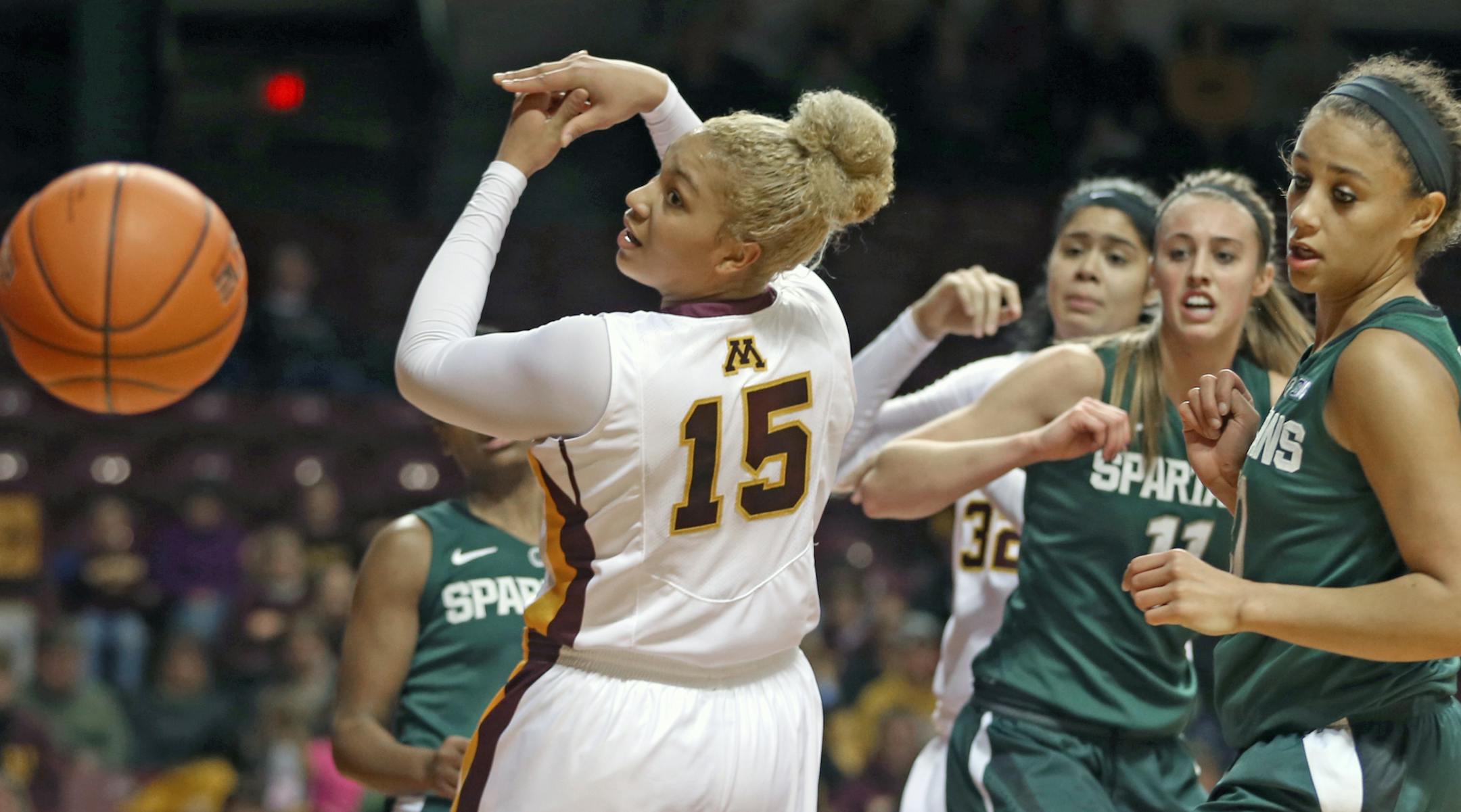 University of Minnesota Women's Basketball, 1/4/14, Gophers vs. Michigan State, (left to right) Minnesota's Micaella Riche and the Michigan State defense chased a rebound in first half action.] Bruce Bisping/Star Tribune bbisping@startribune.com Micaella Riche/roster.
