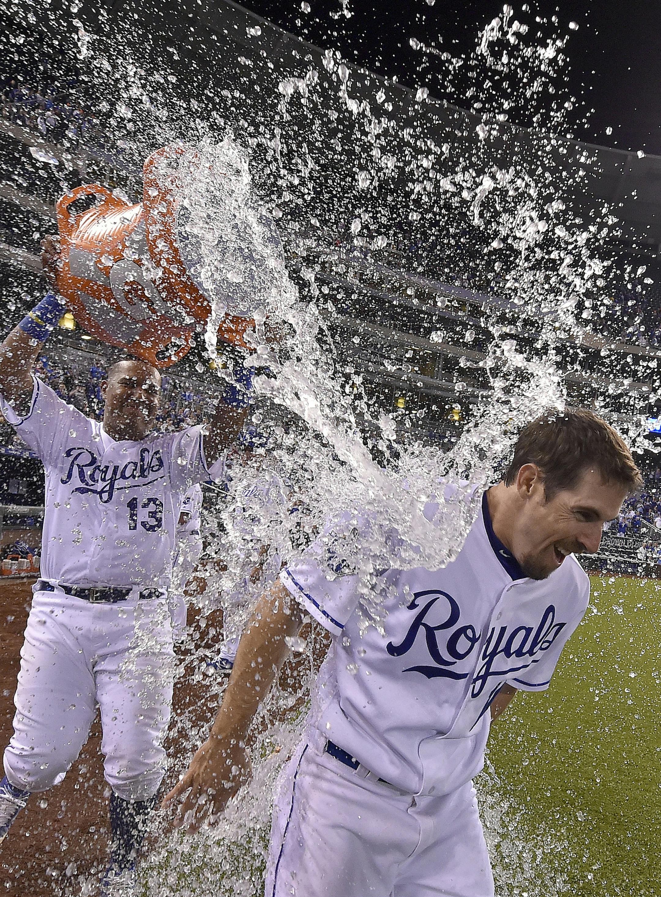 The Kansas City Royals' Billy Burns receives a victory shower from teammate Salvador Perez after Burns' game-winning sacrifice fly to score Raul Mondesi for a 4-3 win in the 11th inning against the Minnesota Twins on Tuesday, Sept. 27, 2016, Kauffman Stadium in Kansas City, Mo. (John Sleezer/Kansas City Star/TNS)