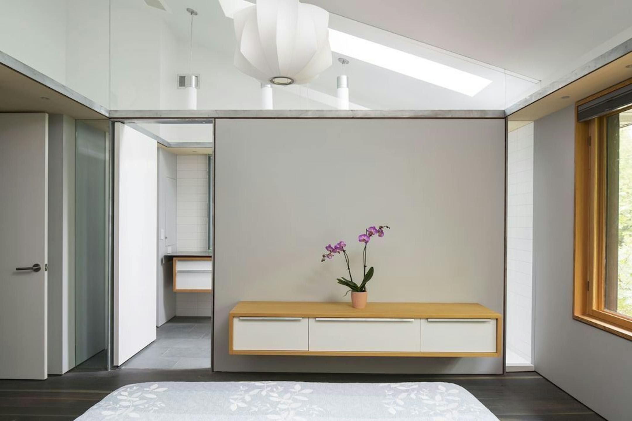 Spare Asian-style renovated owners' suite features a ceiling-height glass wall, designed by David O'Brien Wagner, SALA Architects.