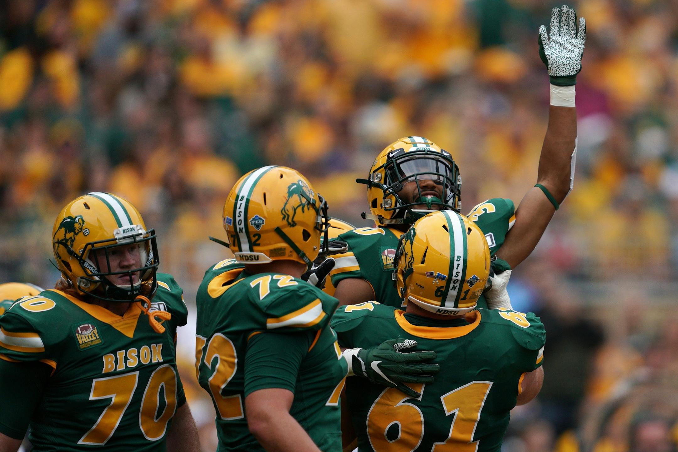 North Dakota State Bison running back Kobe Johnson (24) was hoisted up by his teammates after he ran the ball in for a touchdown in the second half.