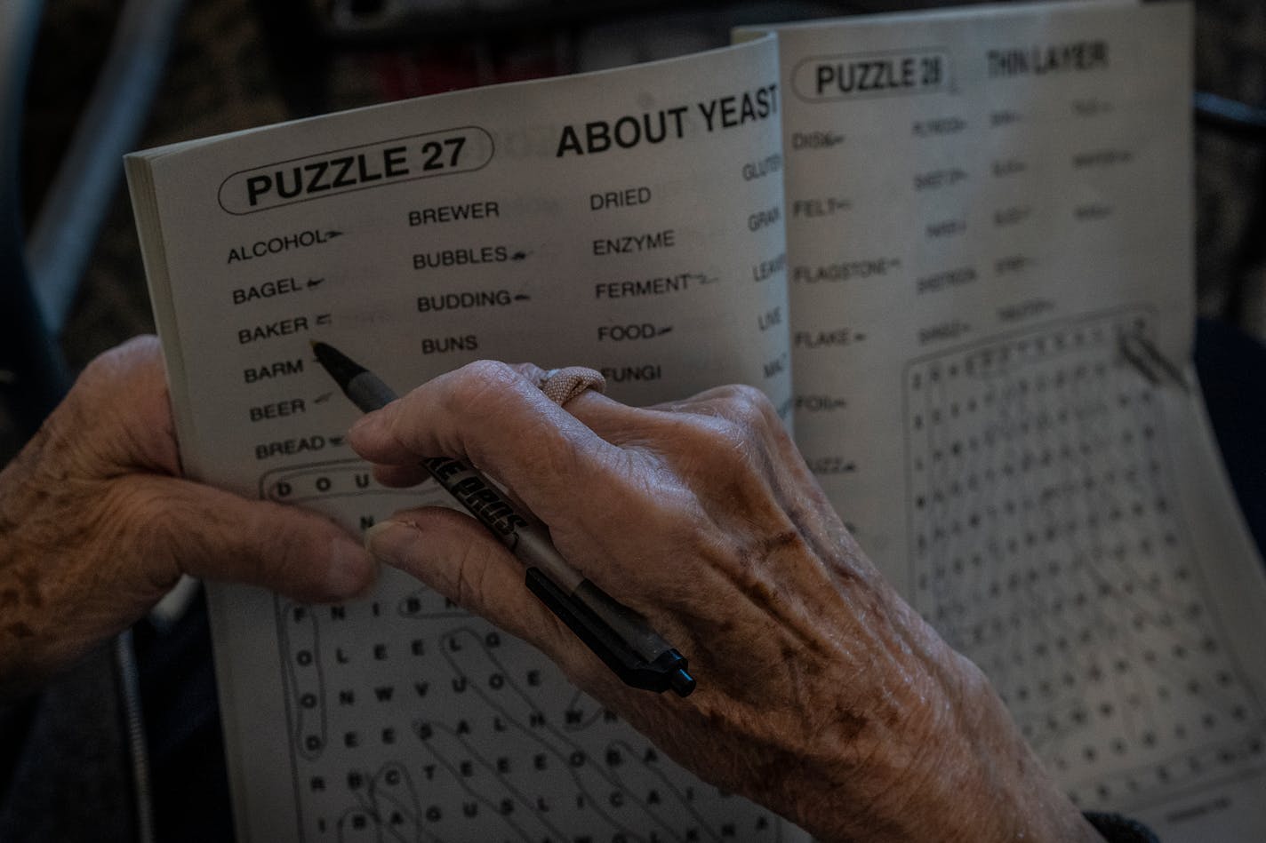 Rosie Eberhard a Oak Meadows Senior Home filled out puzzles as she and other ladies sat in entrance of the senior home Thursday February 25,2021 In Oakdale, MN.] Jerry Holt •Jerry.Holt@startribune.com