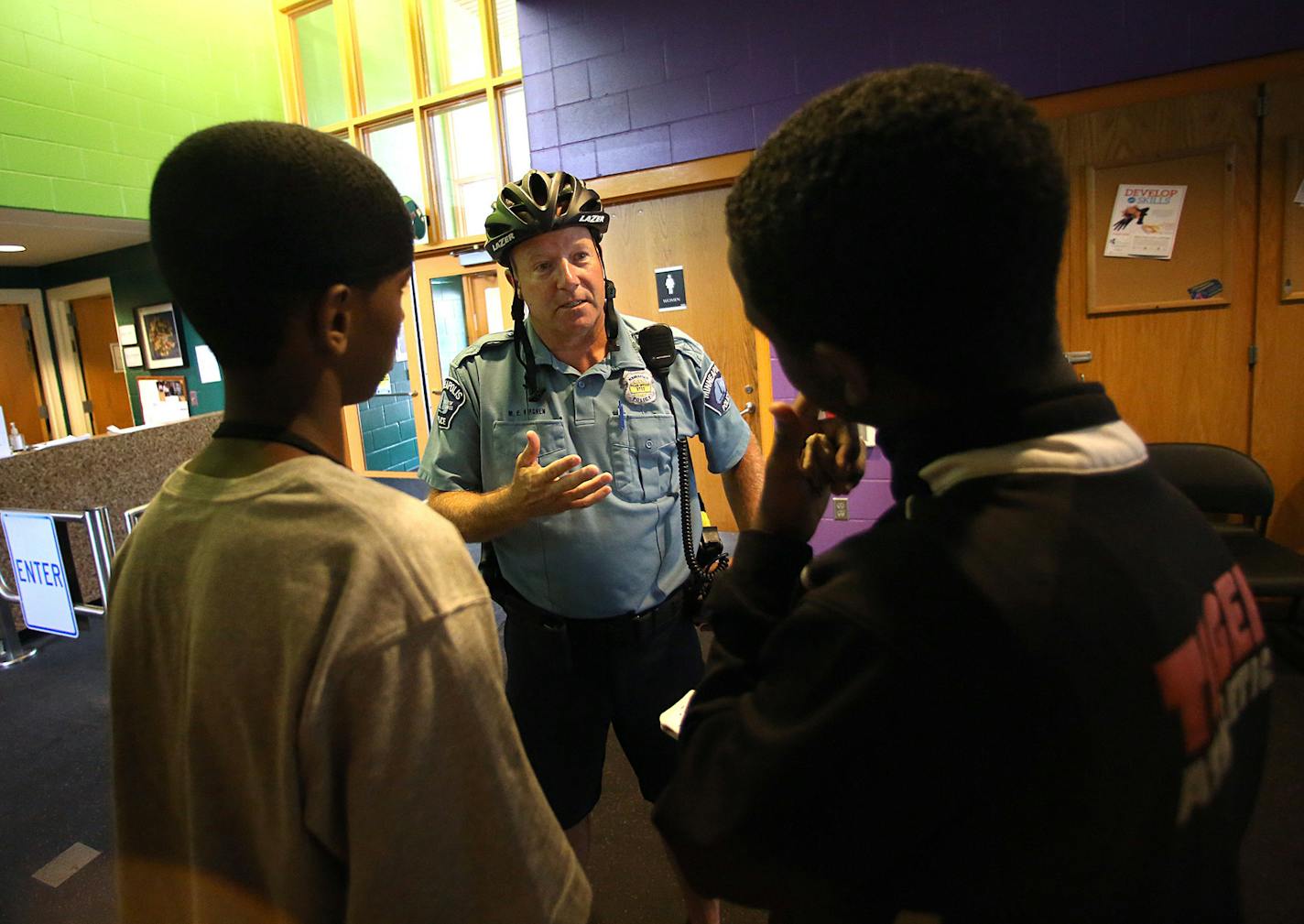 Minneapolis police officer Mike Kirchen interacted with Mohamed Salat (left) and Abdi Ali at the Brian Coyle Center. ] JIM GEHRZ &#x201a;&#xc4;&#xa2; jgehrz@startribune.com / Minneapolis, MN / July 16, 2014 / 1:30 PM / BACKGROUND INFORMATION: For the last year, the U.S. Department of Justice has been working with the city of Minneapolis to develop a national model of community policing within a community of color. Minneapolis beat out a bunch of cities for the opportunity for financial and analy