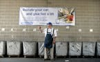 Dan Karnick of Rosemount, a donation receiver at the Goodwill in Apple Valley for 3 years, directs a vehicle into the donation drop-off center at the 
