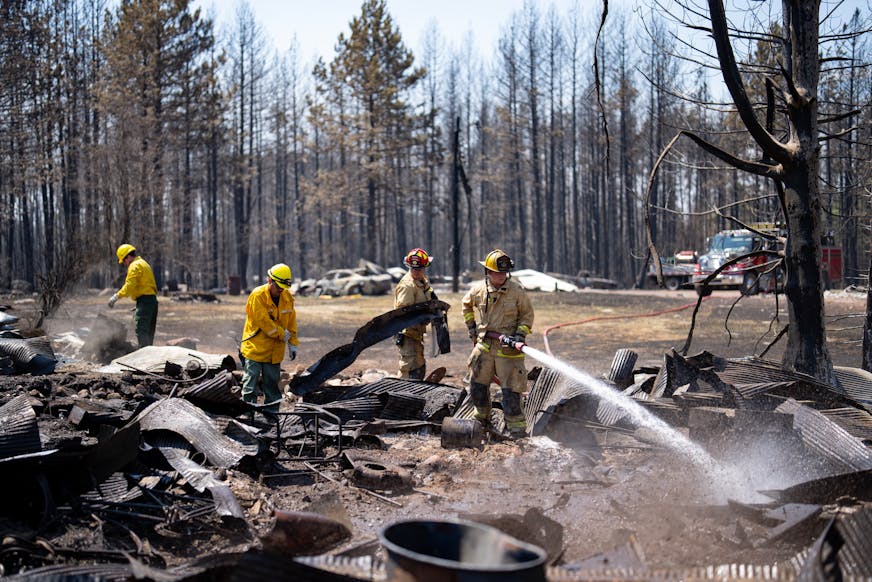 Firefighters Joshua Donahue, Chris Schlosser, Jon Settergren, Michael Hemmerich, left to right, move debris and water down hot spots in the smoldered remains of a structure as part of the efforts to combat the Camp House wildfire in Brimson, Minn. on Thursday, May 15, 2025.   ]

ALEX KORMANN • alex.kormann@startribune.com