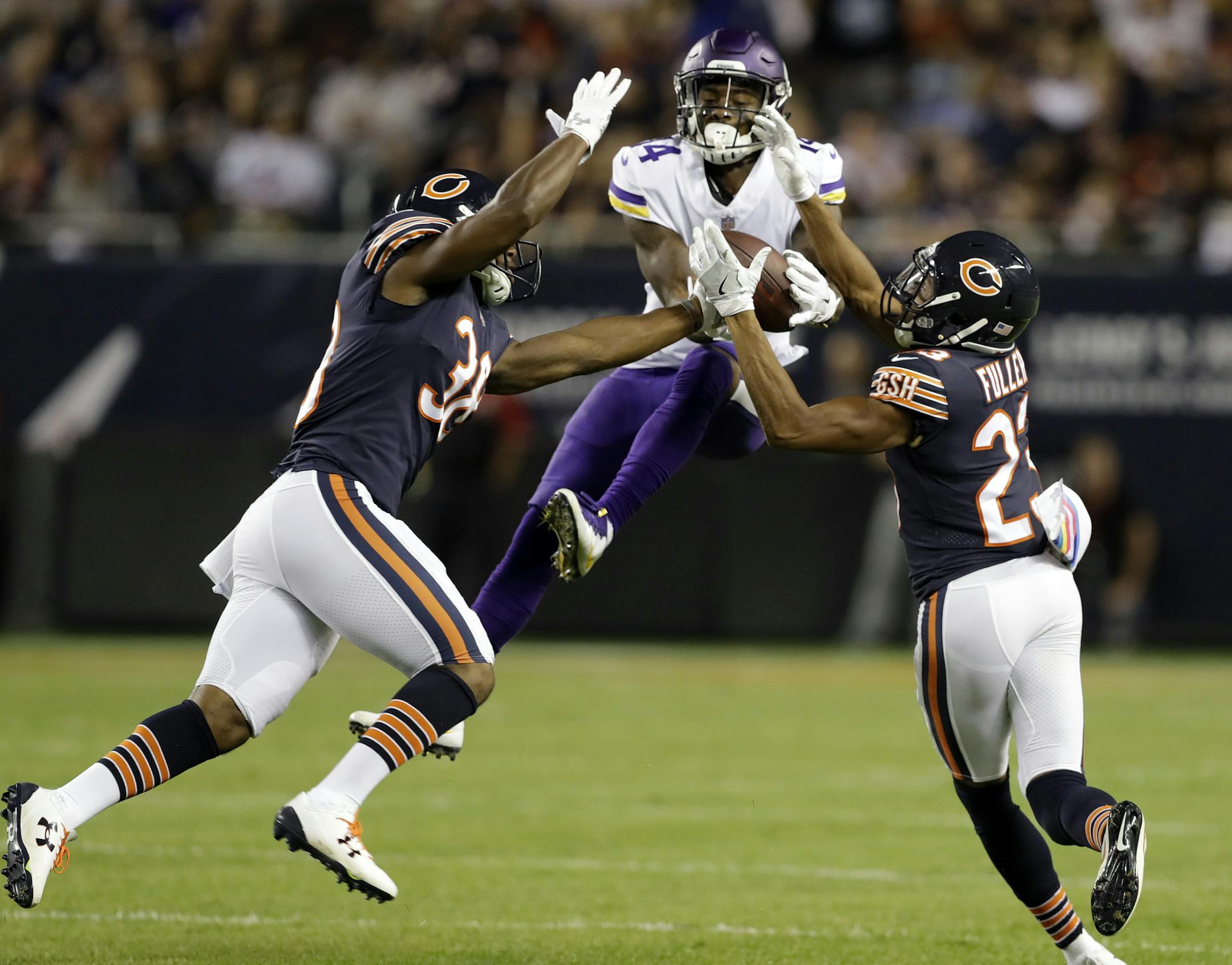Chicago Bears strong safety Adrian Amos (38) and cornerback Kyle Fuller (23) break up a pass intended for Minnesota Vikings wide receiver Stefon Diggs (14) during the first half of an NFL football game, Monday, Oct. 9, 2017, in Chicago. (AP Photo/Darron Cummings)