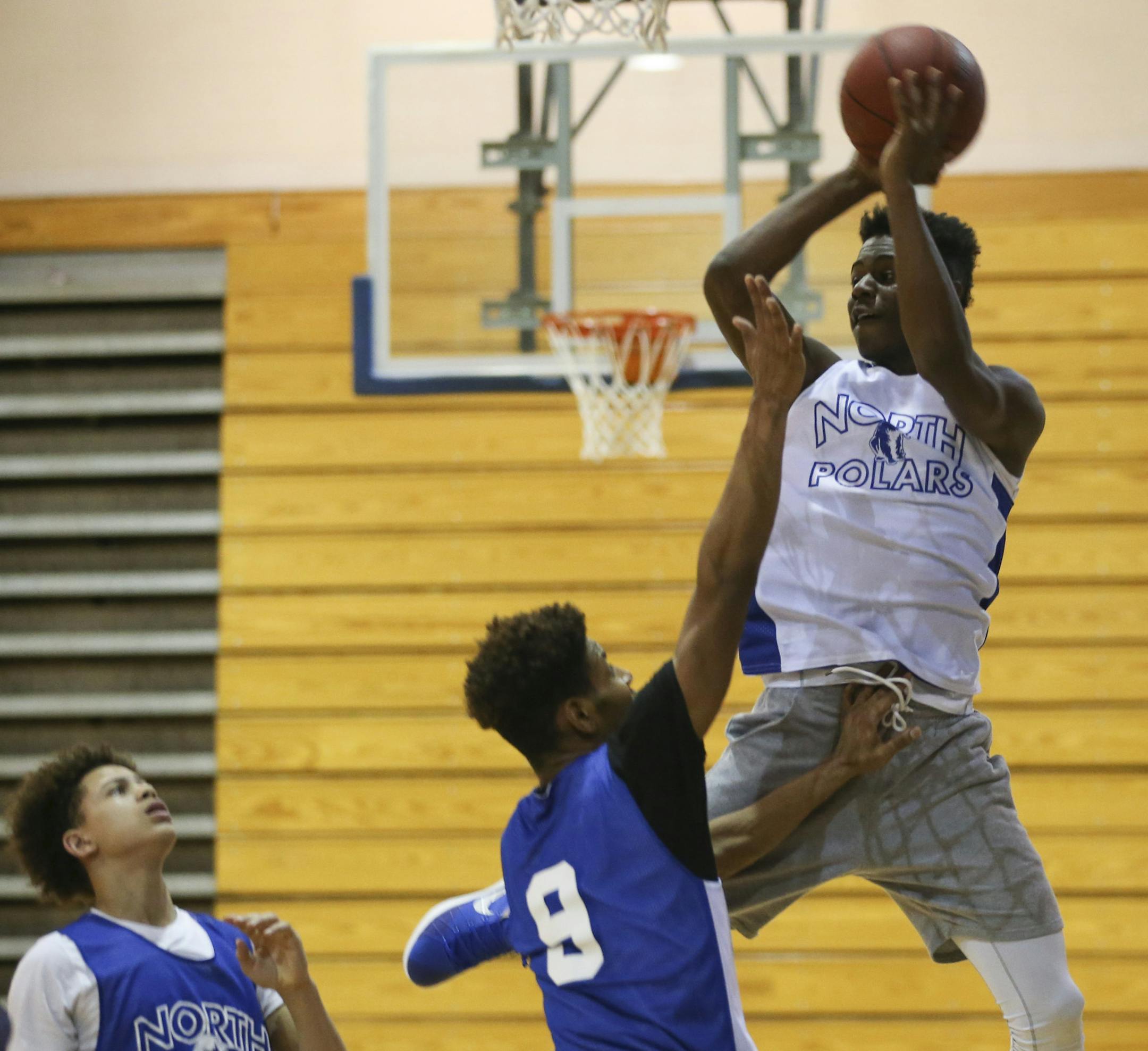 North senior Tyler Johnson looked to pass off during practice while guarded by junior Marquise Holloman Tuesday afternoon. ] JEFF WHEELER • jeff.wheeler@startribune.com Minneapolis North Polars, a program synonymous with basketball excellence, is back in the state tournament for the first time since 2003. They practiced after school Tuesday afternoon, March 8, 2016 ahead of their tournament game on Thursday.