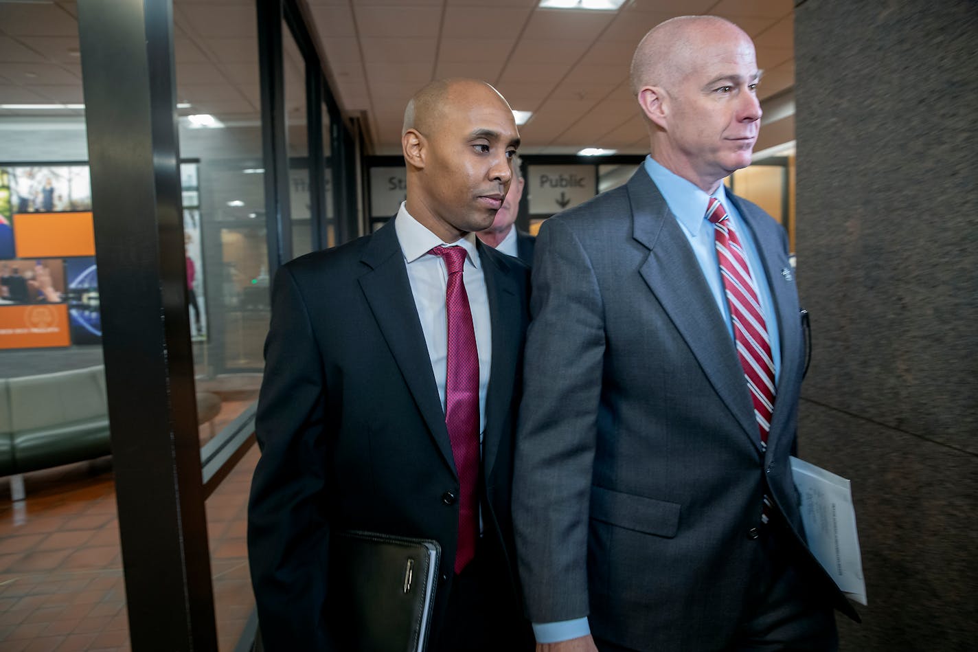 Former Minneapolis police officer Mohamed Noor, left, and his attorney Thomas Plunkett made their way out of court at the Hennepin County Government Center on April 1.