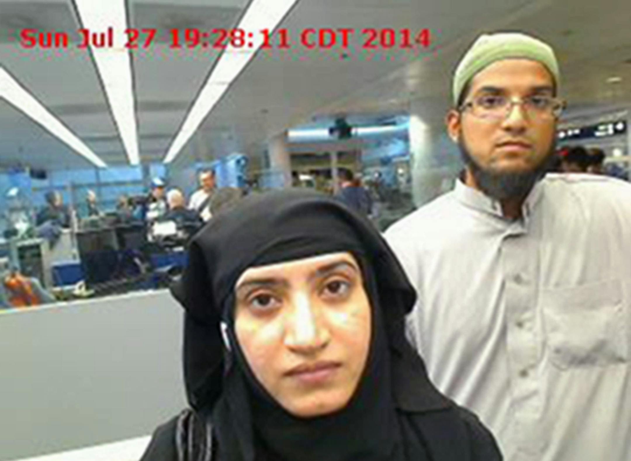 This July 27, 2014 photo provided by U.S. Customs and Border Protection shows Tashfeen Malik, left, and Syed Farook, as they passed through O'Hare International Airport in Chicago. The husband and wife died on Dec. 2, 2015, in a gun battle with authorities several hours after their assault on a gathering of Farook's colleagues in San Bernardino, Calif. (U.S. Customs and Border Protection via AP)