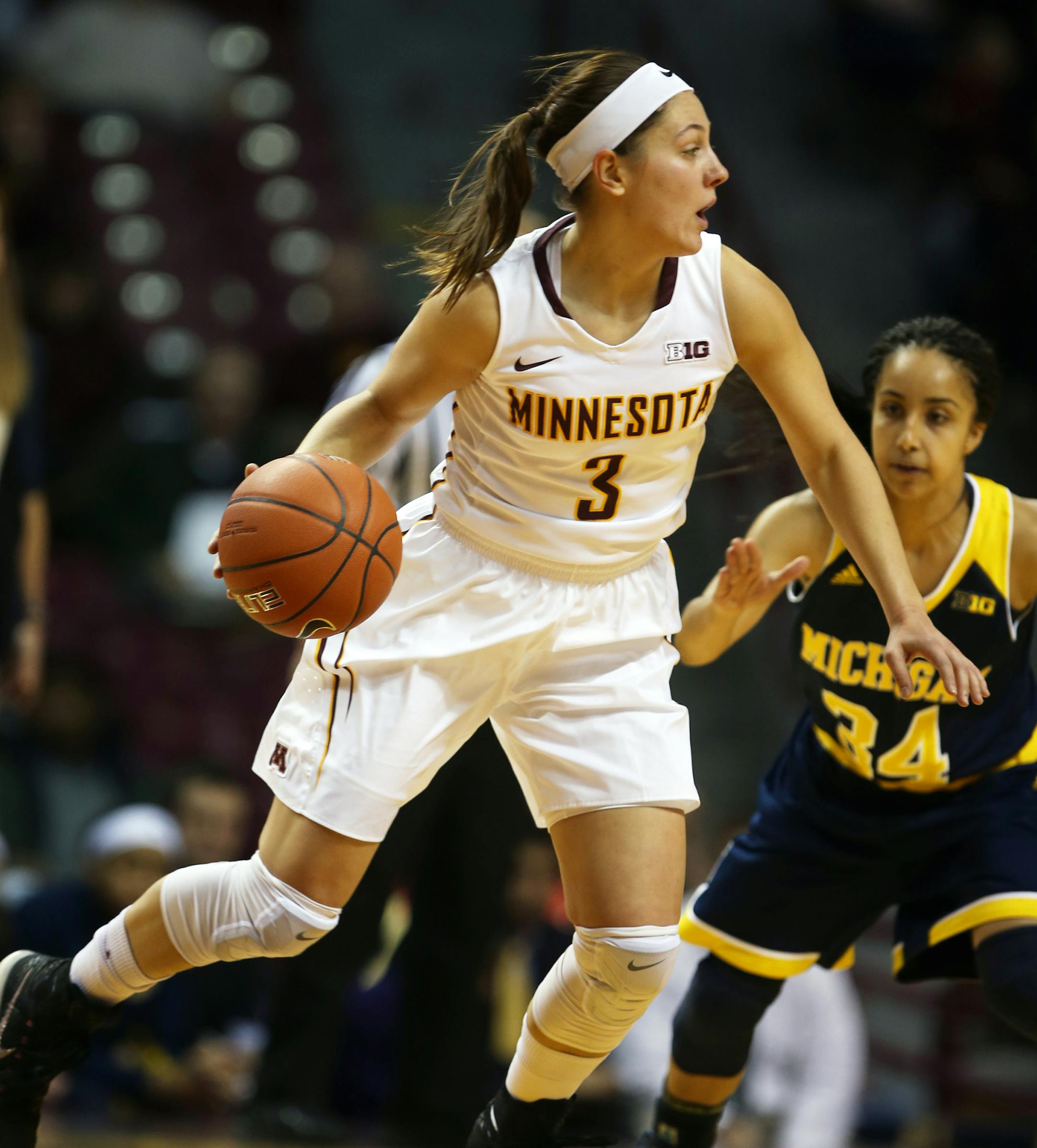 Shayne Mullaney(3) drove on Boogie Brozoski(34).] At Williams Arena in a game between the women's Gophers and Michigan. Richard Tsong-Taatarii/rtsong-taatarii@startribune.com