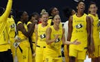 The Seattle Storm celebrate after the team defeated the Minnesota Lynx during Game 3 of a WNBA basketball semifinal round playoff series Sunday, Sept.