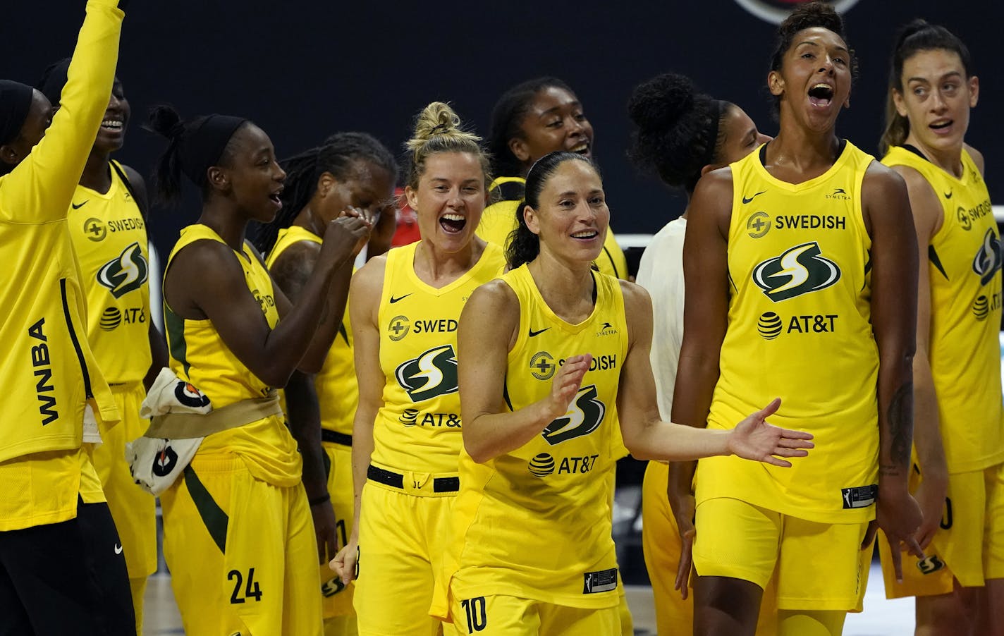 The Seattle Storm celebrate after the team defeated the Minnesota Lynx during Game 3 of a WNBA basketball semifinal round playoff series Sunday, Sept. 27, 2020, in Bradenton, Fla. The Storm move onto the WNBA finals. (AP Photo/Chris O'Meara)