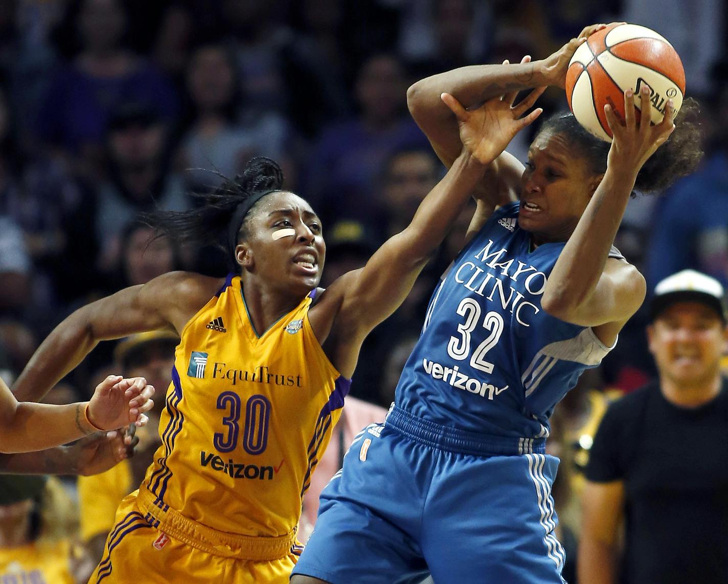 Minnesota Lynx forward Rebekkah Brunson, right, pulls down a rebound against Los Angeles Sparks forward Nneka Ogwumike during the second half in Game 4 of the WNBA basketball finals, Sunday, Oct. 1, 2017, in Los Angeles. The Lynx won 80-69. (AP Photo/Alex Gallardo)