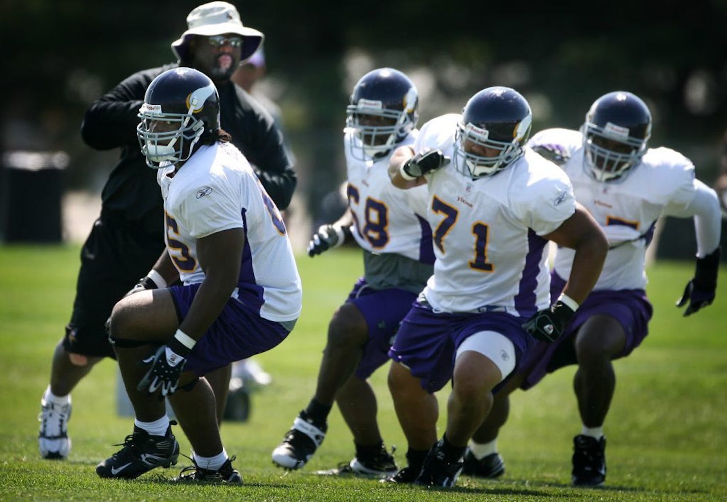 JERRY HOLT �jgholt@startribune.com 7/29/2007---Vikings defensive line coach Karl Dunbar leads the line through drills Sunday afternoon in Mankato.