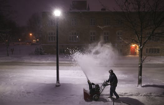Jeff Gatesmith cleared the snow from his walk under the newest type of Minneapolis residential streetlight with downward-facing LEDs and no glass globe.