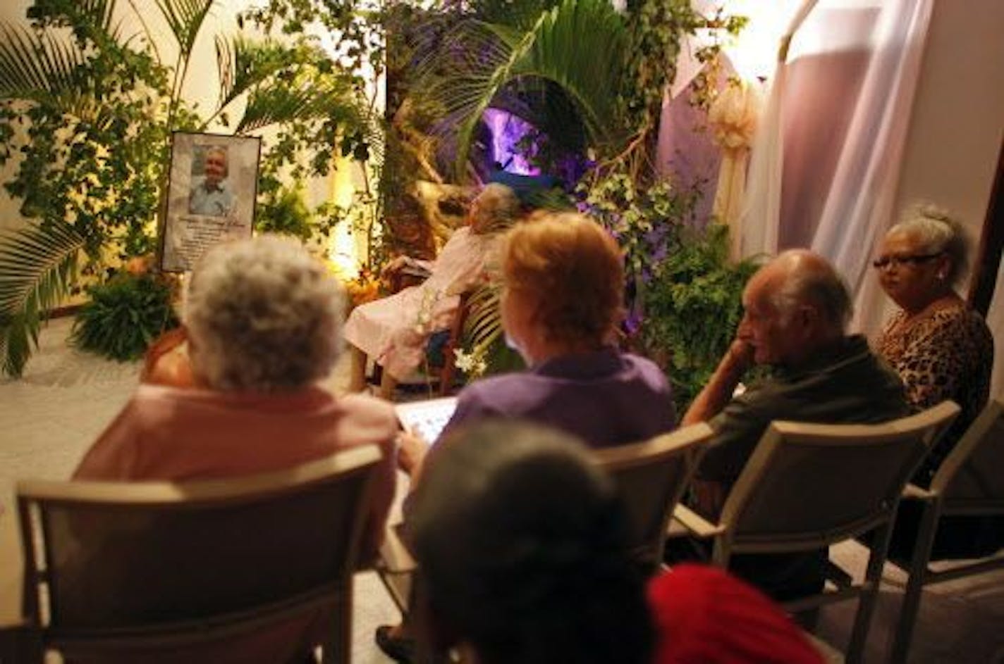 People attend the wake of Georgina Chervony Lloren, who wanted her funeral to be in her favorite rocking chair and in her wedding gown from her second marriage 32 year ago.