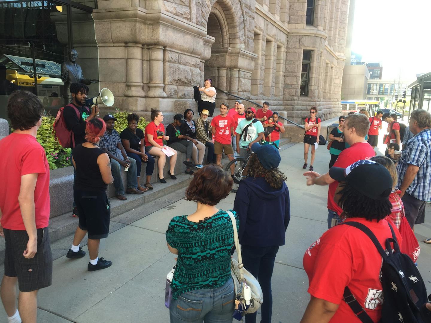 Neighborhoods Organizing for Change organizer Rod Adams addresses a crowd outside City Hall Wednesday.