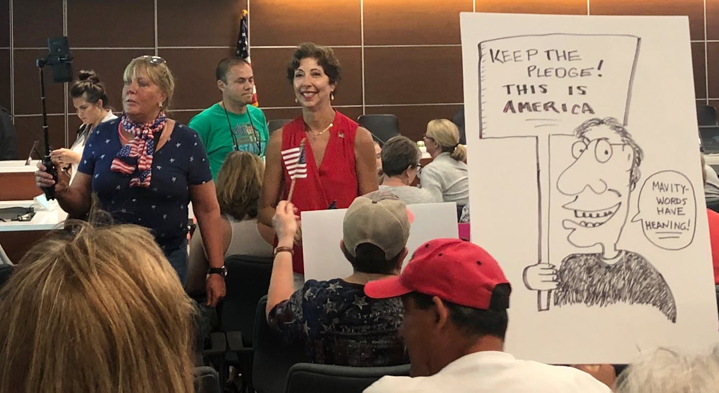 More than 100 people packed the St. Louis Park council chambers Monday night to protest a decision to do away with the Pledge of Allegiance at most meetings.