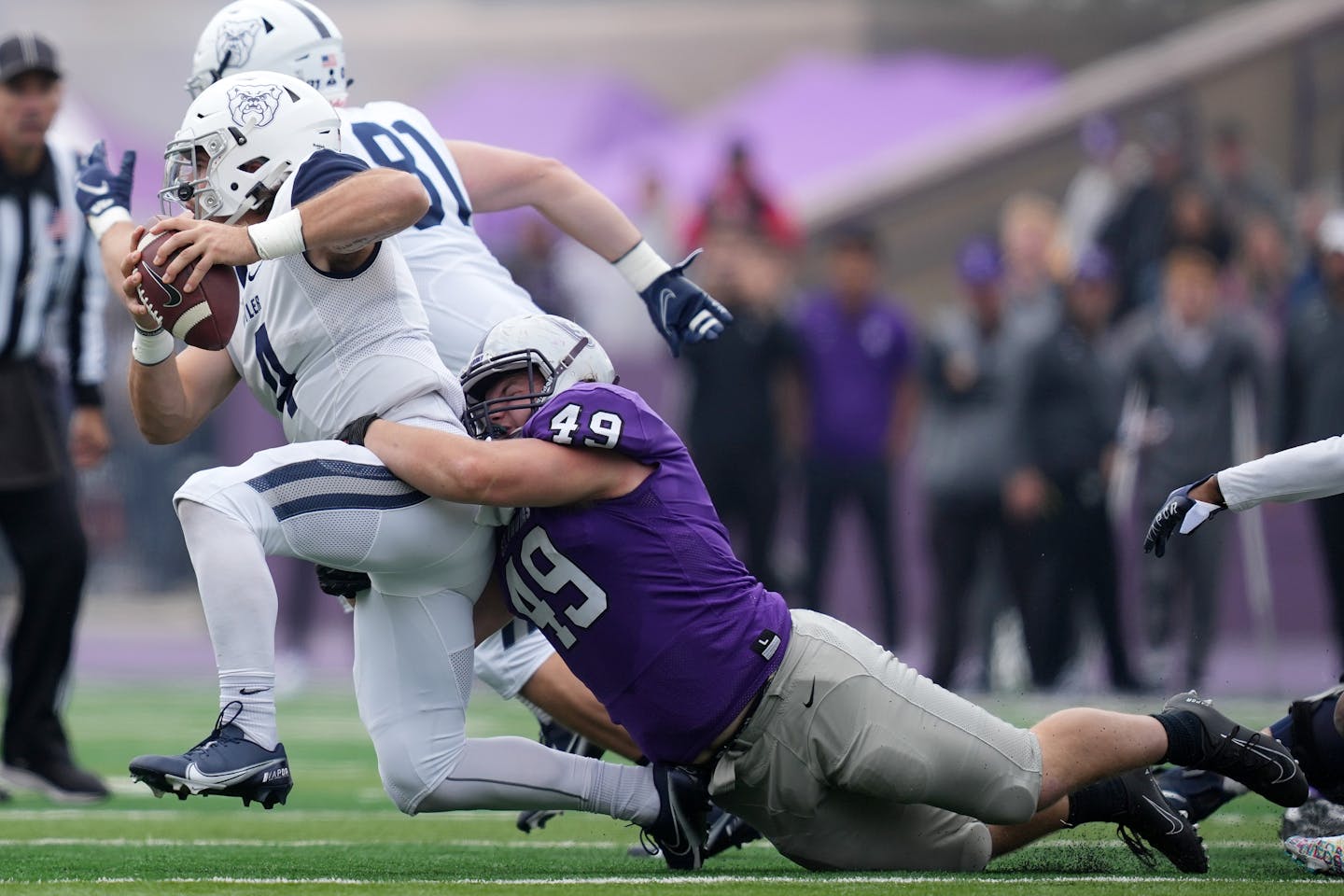 St. Thomas defensive lineman Brent Robley (49) got his arm around Butler quarterback Bret Bushka (4) as he scrambled out of the pocket in the second quarter. ] ANTHONY SOUFFLE • anthony.souffle@startribune.com