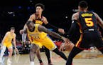 Lakers star LeBron James (23) drives with the ball against the Hawks' Dejountee Murray (5) during the first half Monday.