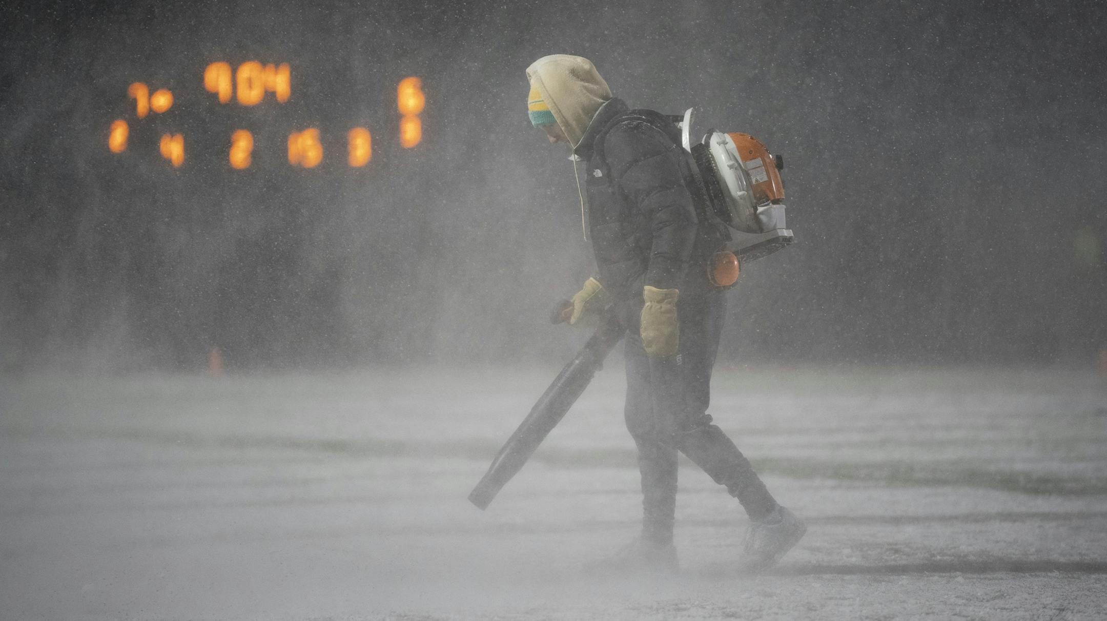 A grounds crew member blew snow off the yard lines during a third quarter timeout. ] JEFF WHEELER ï jeff.wheeler@startribune.com Eden Prairie defeated Minnetonka 15-13 in their Class 6A football quarterfinal playoff game Thursday night, November 8, 2018 at Chanhassen High School.