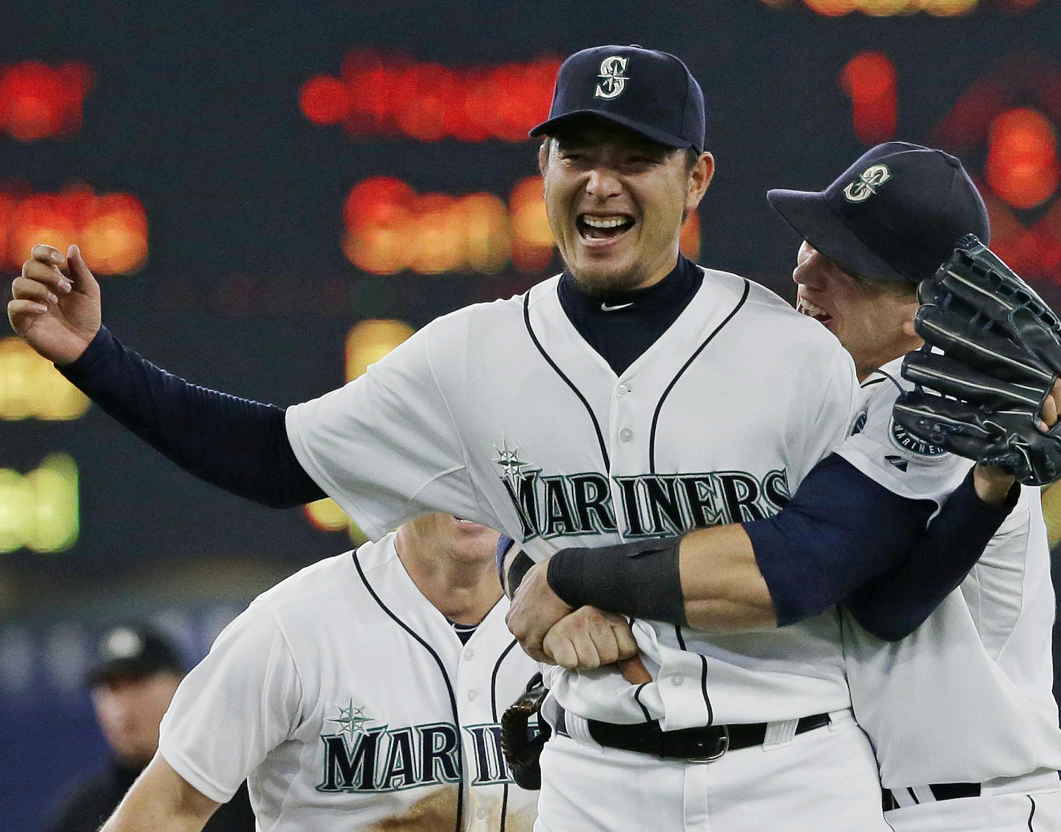 Seattle Mariners starting pitcher Hisashi Iwakuma is hugged by first baseman Logan Morrison, right, after the final out of Iwakuma's no-hitter against the Baltimore Orioles in a baseball game Wednesday, Aug. 12, 2015, in Seattle. The Mariners won 3-0. (AP Photo/Ted S. Warren)