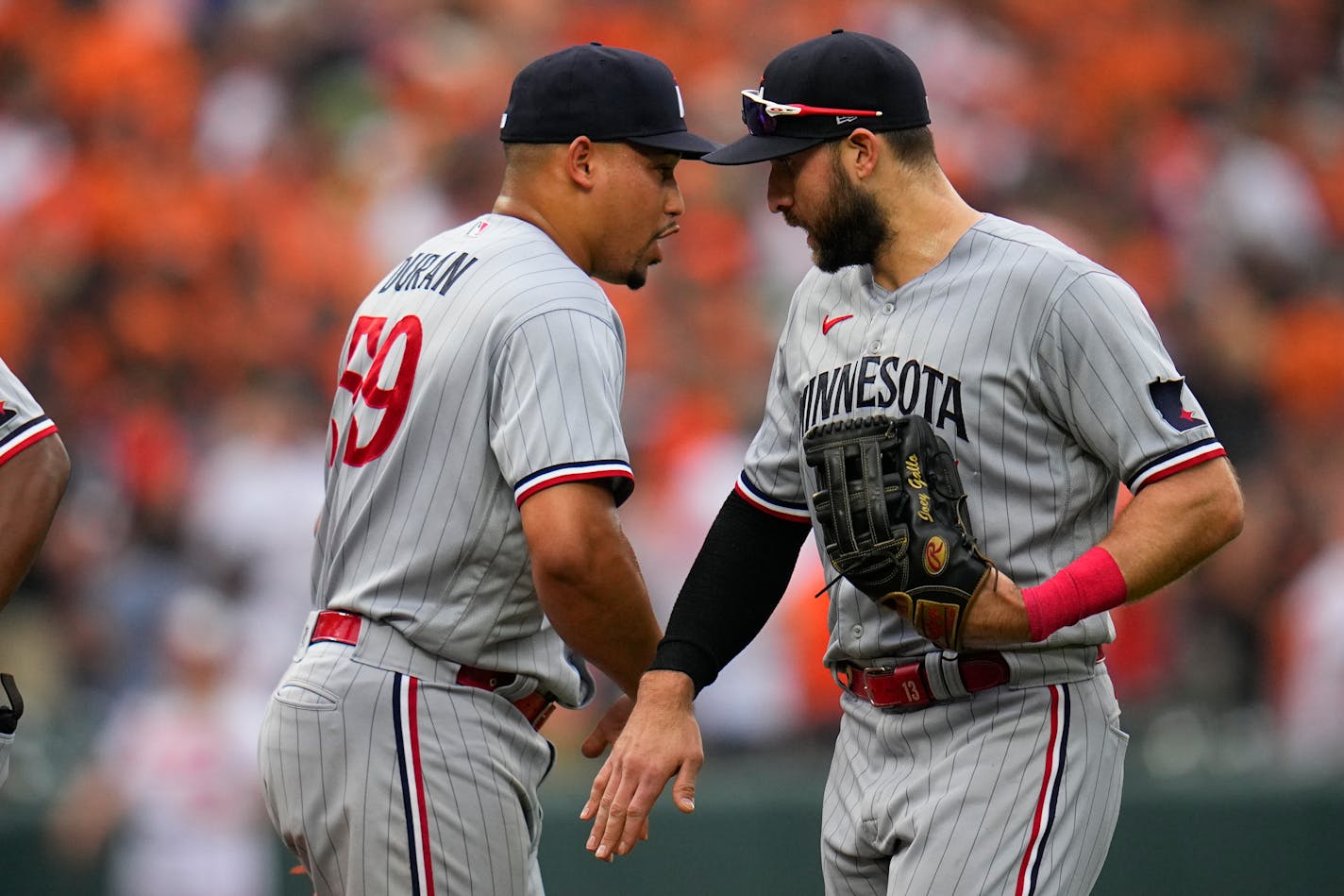 Minnesota Twins relief pitcher Jhoan Duran, left, and first baseman Joey Gallo celebrate after a baseball game against the Baltimore Orioles, Saturday, July 1, 2023, in Baltimore. The Twins won 1-0. (AP Photo/Julio Cortez)