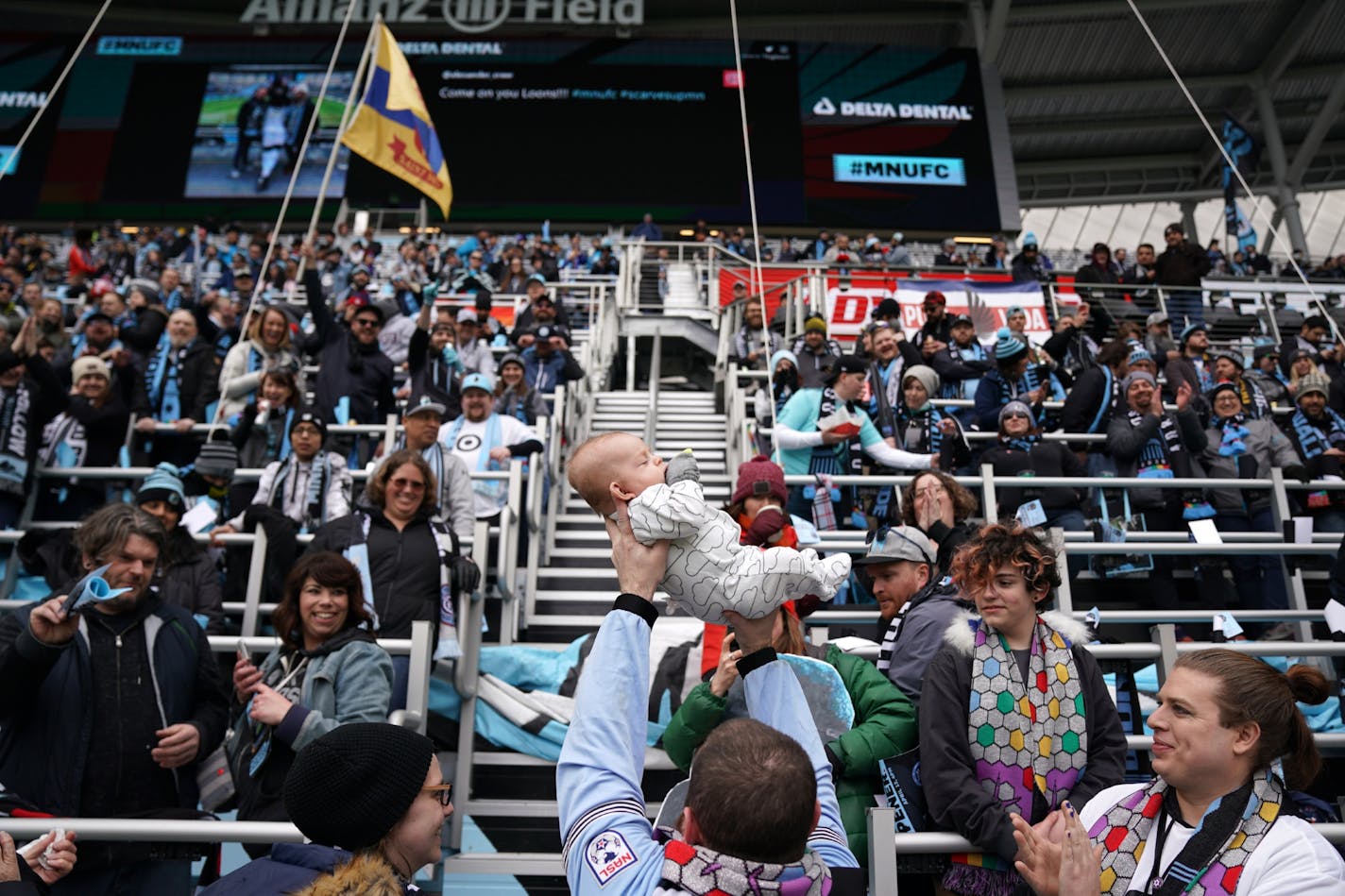 Minnesota United fan David Zeller held up his 3-month-old son Ragnar Zellburg "Lion King" style as fellow fans cheered ahead of Saturday's home opener against New York City at Allianz Field.