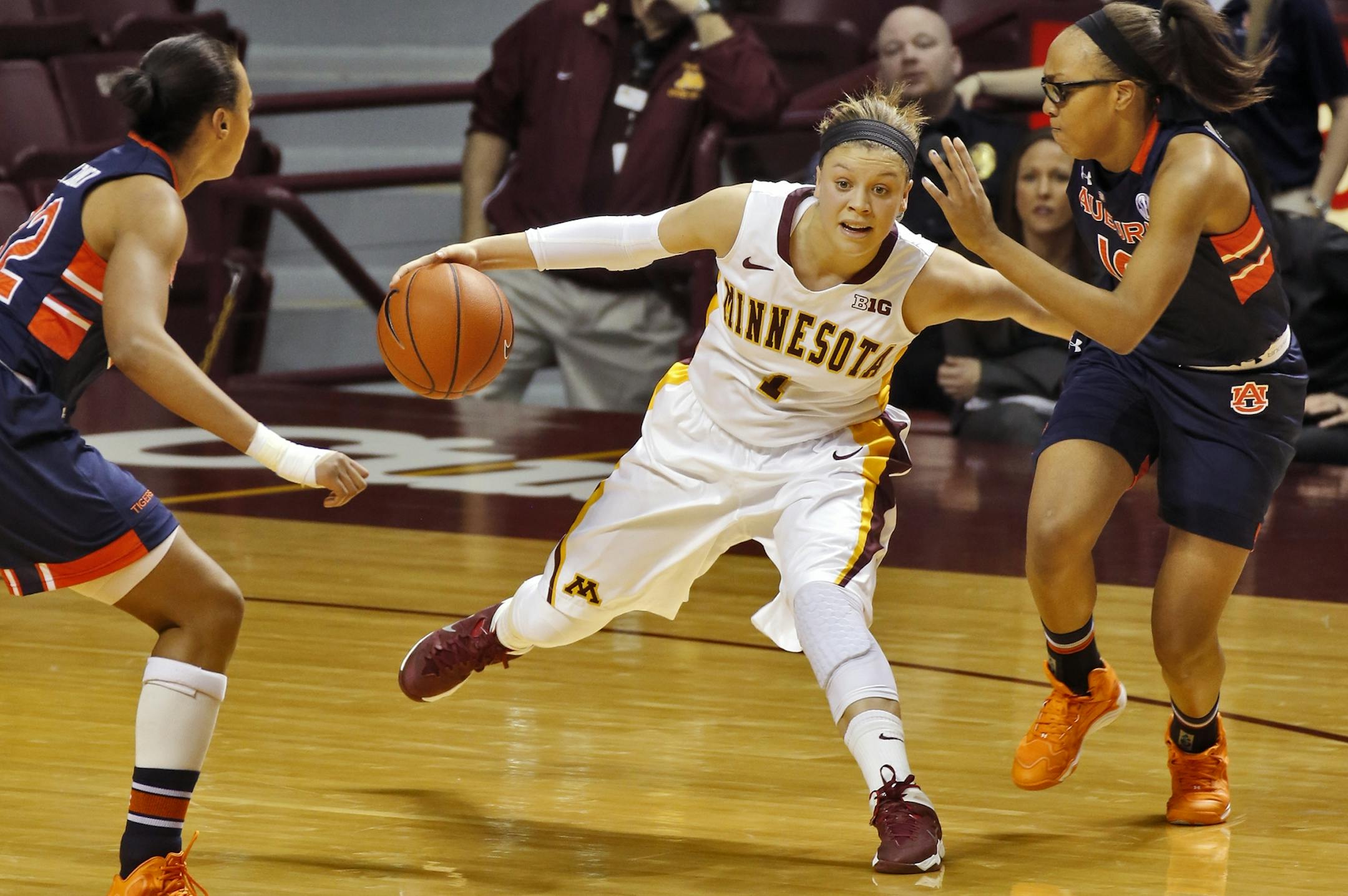 Minnesota Gophers vs. Auburn Tigers womens basketball. Minnesota's Rachel Banham split the Auburn defenders as she headed upcourt with the ball.
