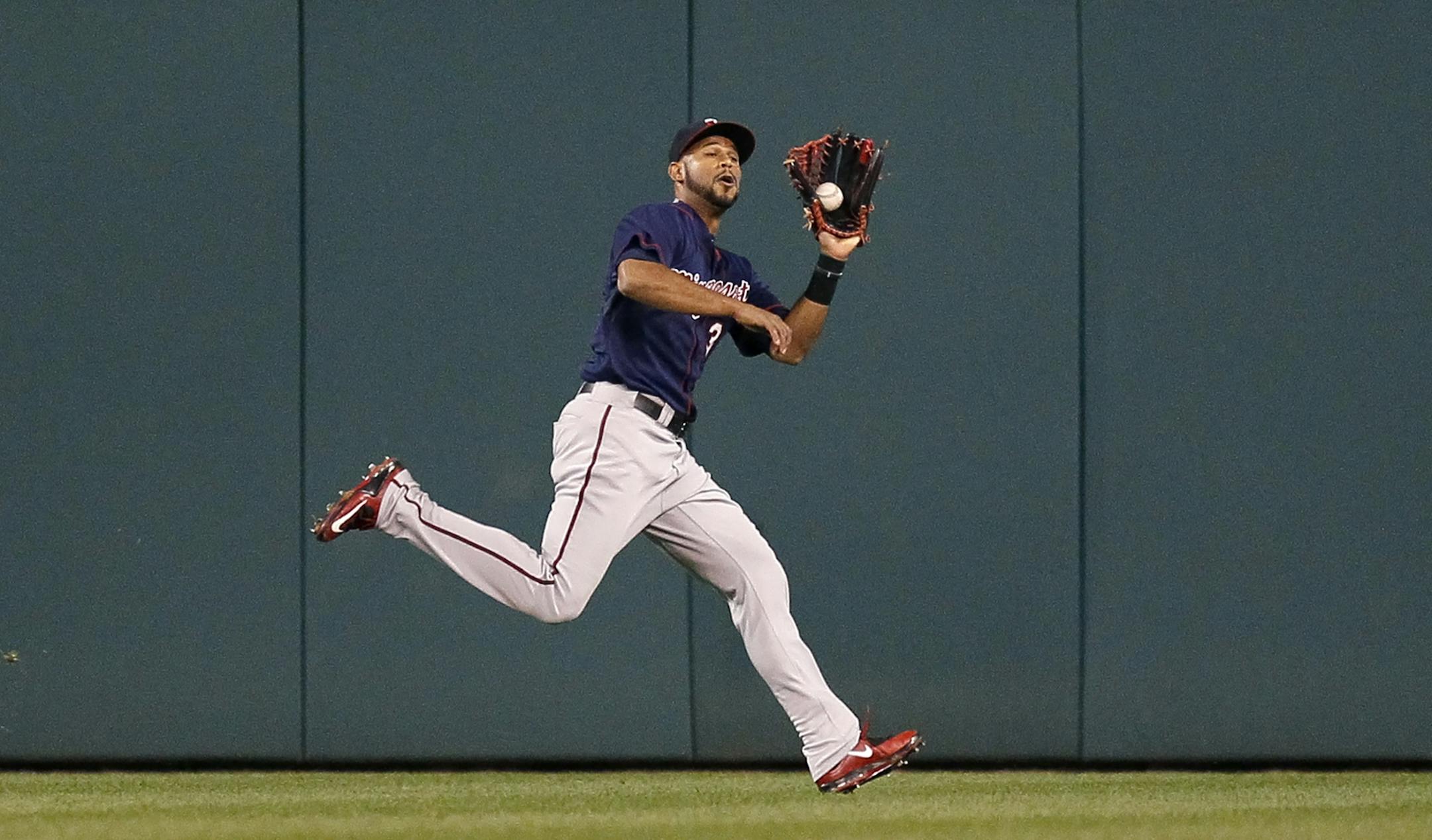 Minnesota Twins center fielder Aaron Hicks catches a fly ball hit by Detroit Tigers' Rajai Davis for an out during the third inning of a baseball game at Comerica Park, Friday, Sept. 25, 2015, in Detroit. (AP Photo/Duane Burleson)