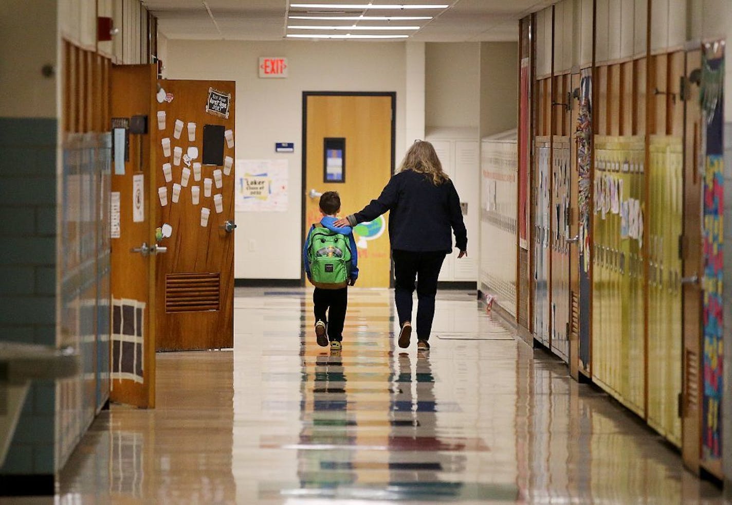 Jolie Holland, left, a nurse in the Howard Lake-Waverly-Winstead School district, comforted a student in 2019. Minnesota health officials said Sunday that a confirmed case of the novel coronavirus here won't automatically trigger school closures.