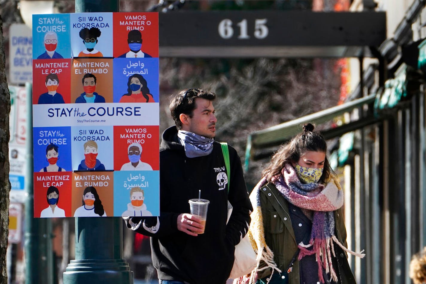 A sign in multiple languages encourages citizens to wear face coverings to help prevent the spread of COVID-19, Tuesday, Nov. 17, 2020, in Portland, Maine. (AP Photo/Robert F. Bukaty)