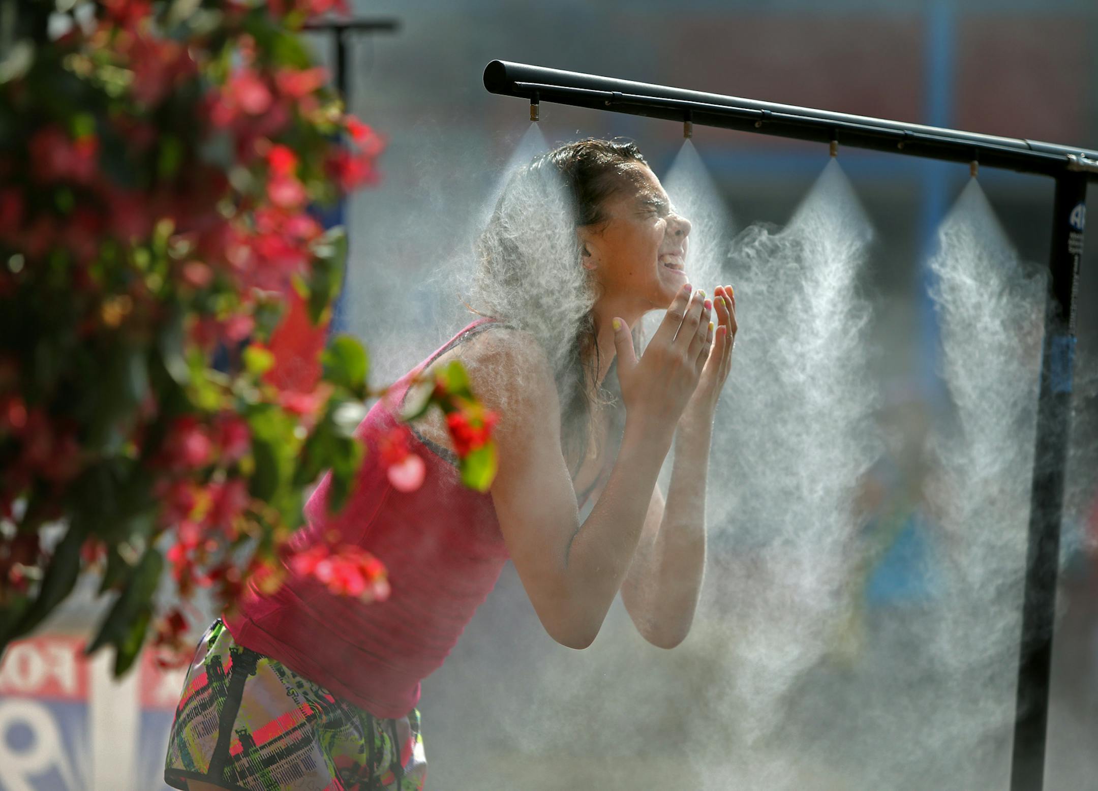 Late last August, Alicia Flores of Eau Claire, Wis., took to the sprinkler systems that were provided for fairgoers to cope with the heat at the Minnesota State Fair.