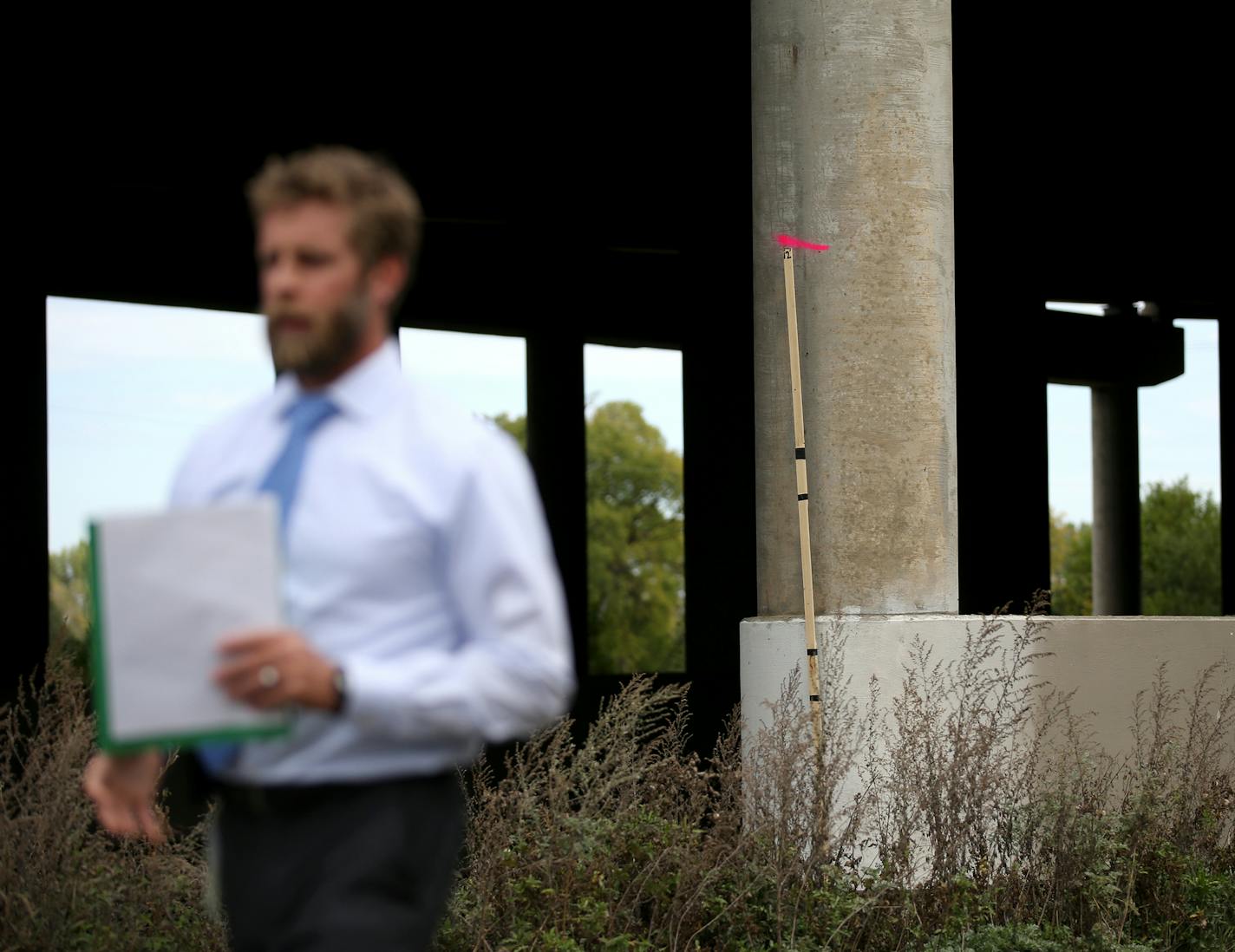 Southwest LRT officials will lead a tour of the area where a 10-foot wall is proposed. Here, Brian Runzel, SWLRT Construction Director, walks near a marker on a support beam where a 10-foot wall will divide freight and passenger trains, seen under the I-394 Bridge near the Bryn Mawr Station Area during a tour Thursday, Sept. 28, 2017, in Minneapolis, MN.] DAVID JOLES &#xef; david.joles@startribune.com Controversy continues to stir over a proposed 10-foot concrete wall that will separate freight