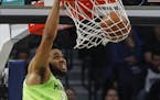 Minnesota Timberwolves' Karl-Anthony Towns dunks against the New Orleans Pelicans watch the second half of an NBA basketball game Saturday, Jan. 12, 2