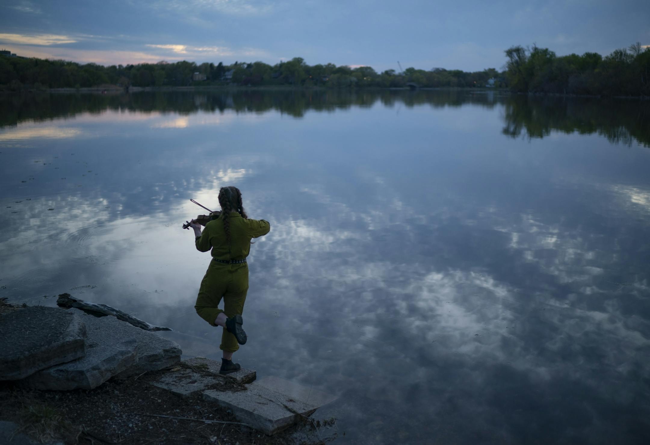 Mia Miller played her violin at Lake of the Isles just after sunset Tuesday night.