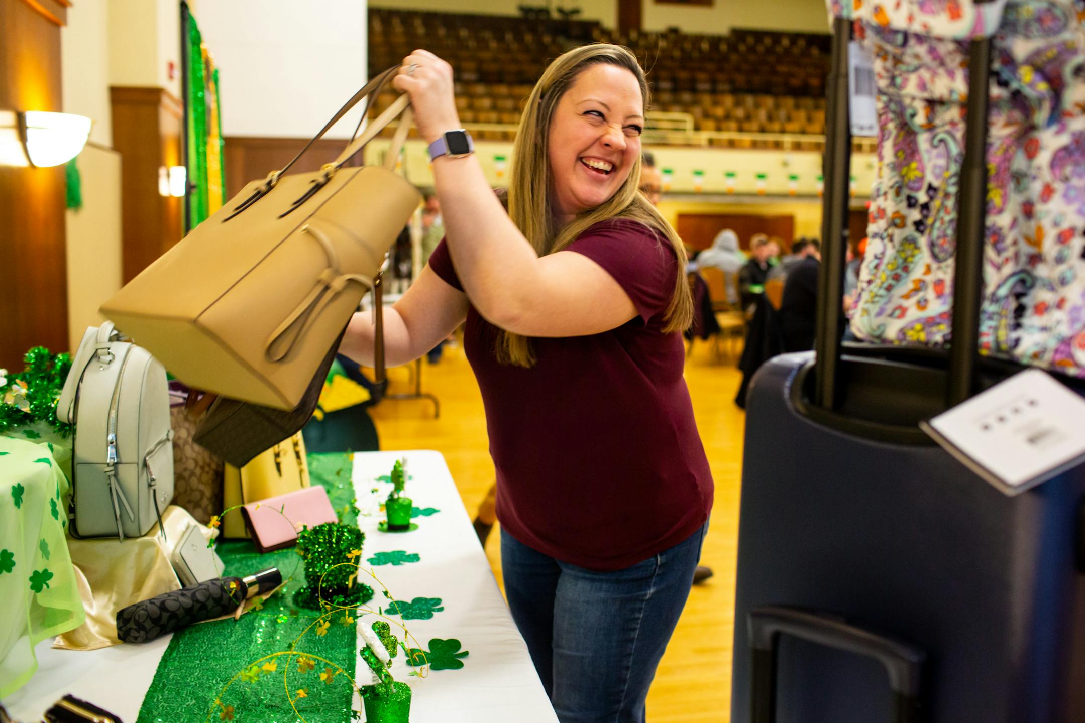 Cassie Anderson chooses a Michael Kors set after winning during Designer Purse & Gun Bingo.