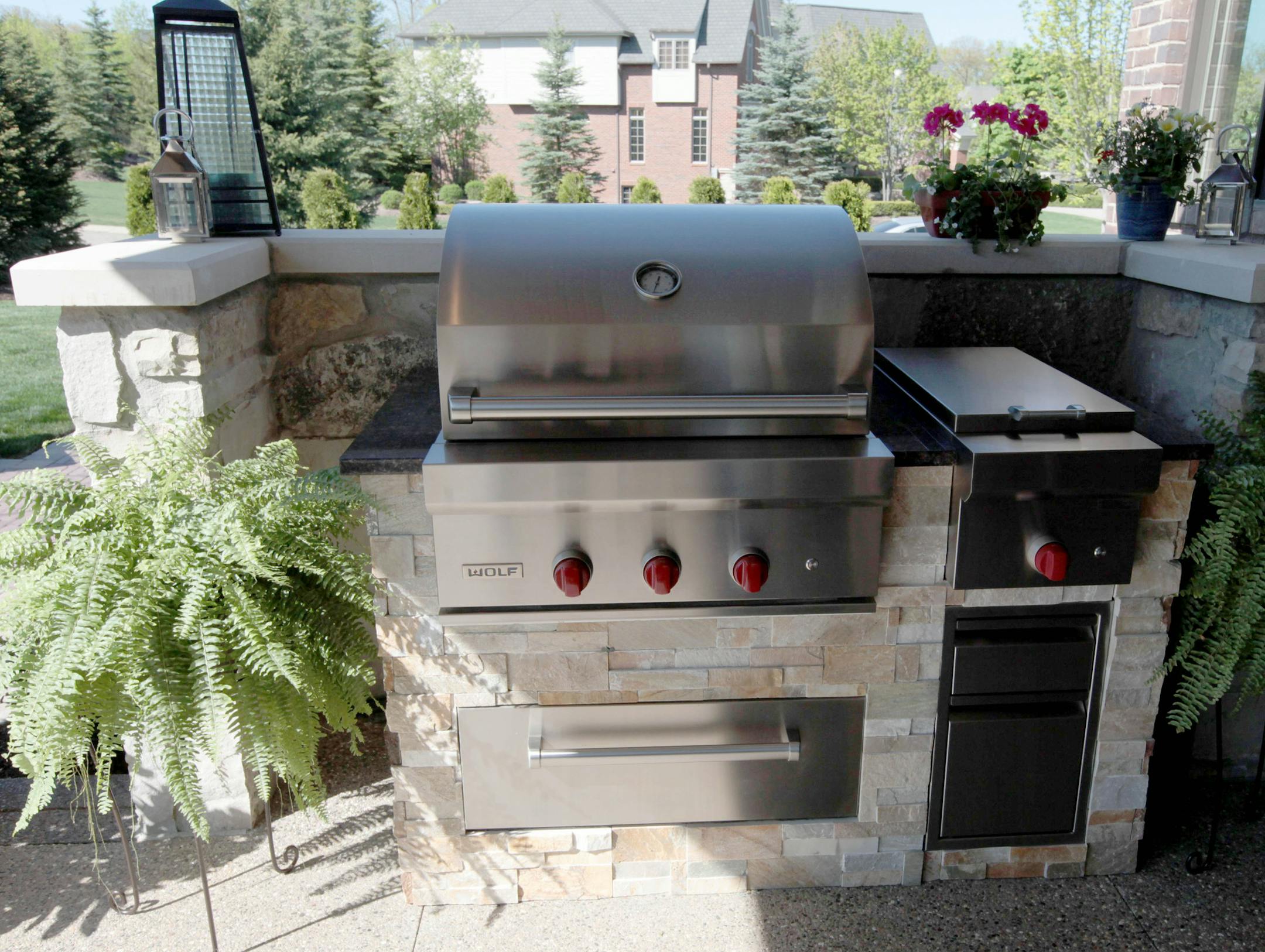 One of the hottest trends in home design is bringing the kitchen outdoors to make grilling more than just for burgers. This model home in Oakland Township, Michigan, features an outdoor kitchen area with a Wolf oven with warming drawers. (Jessica J. Trevino/Detroit Free Press/MCT) ORG XMIT: 1139060
