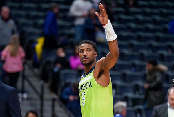 Timberwolves guard Malik Beasley waves to the crowd as he leaves the court after the team's loss to the Nuggets
